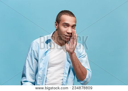 Secret, Gossip Concept. Young Man Whispering A Secret Behind His Hand. Afro Businessman Isolated On 