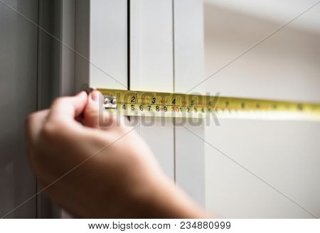 Man measuring with yellow meassure tape