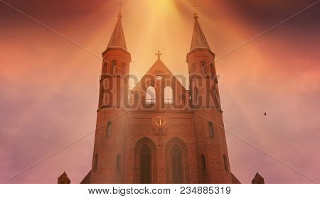 Cathedral Against The Sky .  A Typical View Of Old Town .  Dark Sky With Sun . God Rays . Germany