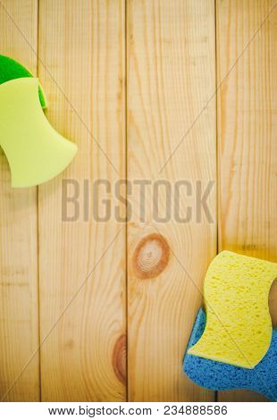 Cleaning House Or Office Concept. Yellow Plastic Bottle With Spayer And Sponges On A Natural Wooden 