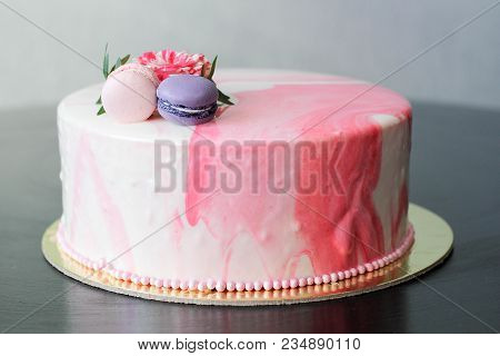 Tasty Pink Homemade Cake Decorated By Rose And Macarons. Marbelous Effect On Cake