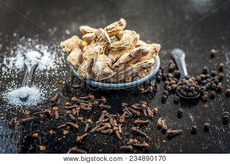 Close Up Of Ayurvedic Herb Or Folk Medicine Dried Ginger Or Zingiber Officinale With Black Pepper Co