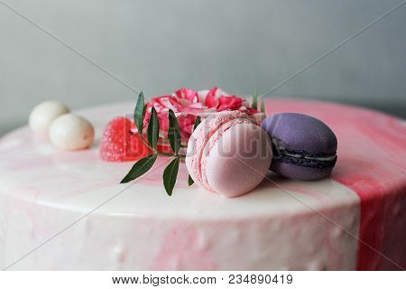 Tasty Pink Homemade Cake Decorated By Rose And Macarons. Marbelous Effect On Cake