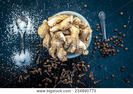 Close Up Of Ayurvedic Herb Or Folk Medicine Dried Ginger Or Zingiber Officinale With Black Pepper Co