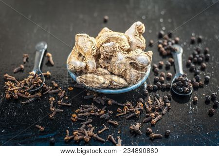 Close Up Of Ayurvedic Herb Or Folk Medicine Dried Ginger Or Zingiber Officinale With Black Pepper Co