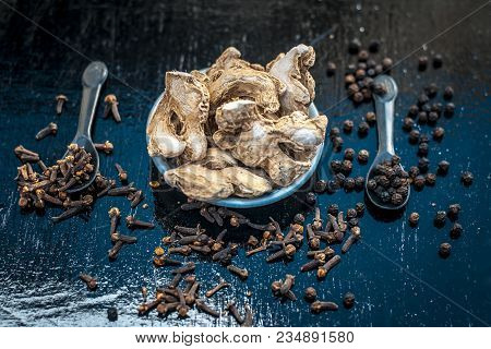 Close Up Of Ayurvedic Herb Or Folk Medicine Dried Ginger Or Zingiber Officinale With Black Pepper Co