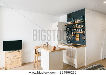 Design Of Modern Home Kitchen In The Attic And Rustic Style. Black Wall With Shelves, Trays, Jars, M