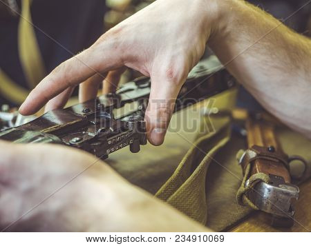 Man Disassemble Rifle Close Up On The Table