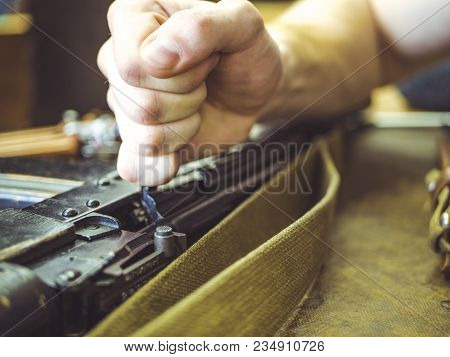 Man Disassemble Rifle Close Up On The Table