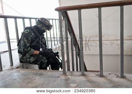 Special Forces Armed Marksmen With Weapon In Building During A Special Operation.