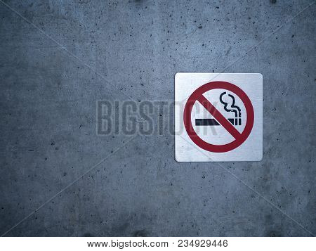 No Smoking Sign Affixed To A Wall On A Building Outside