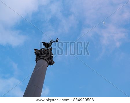 Dewey Monument Pointing Up To A Half Moon In Union Square In San Francisco, Ca.