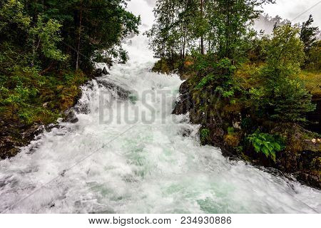 Side Stream Of A Langfoss Weaterfall In Norway Causing A Flood In A Rainy Weather