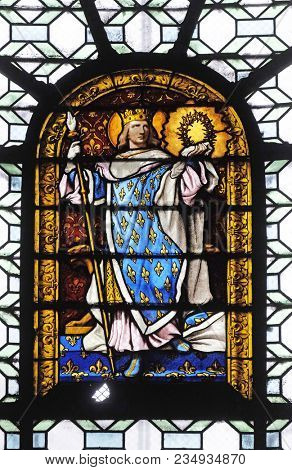 PARIS, FRANCE - JANUARY 04: Saint Louis, stained glass window in the Saint Sulpice Church, Paris, France on January 04, 2018.