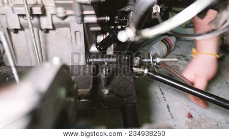 Mechanic Position With Open End Wrench Unscrew The Nut From The Stud, Dismantle The Car, Closeup.