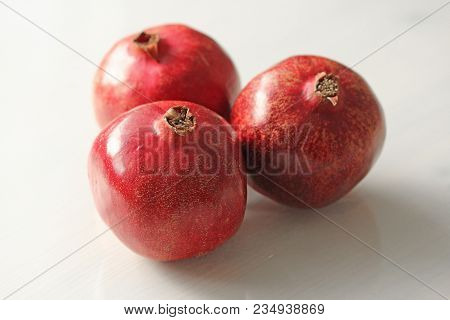 Big Ripe Red Granets Or Garnets. Fruits Of Red Ripe Pomegranate On The White Background. Vegetarian 