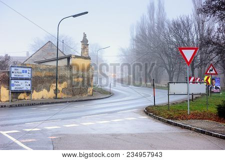 Guntersdorf, Austria - December 28, 2017. Vehicles Moving On A Winding Country Road Through Historic