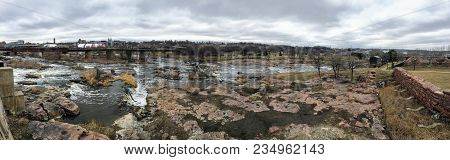 The Big Sioux River Flows Over Rocks In Sioux Falls South Dakota With Views Of Wildlife, Ruins, Park