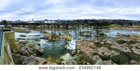 The Big Sioux River Flows Over Rocks In Sioux Falls South Dakota With Views Of Wildlife, Ruins, Park