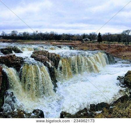 The Big Sioux River Flows Over Rocks In Sioux Falls South Dakota With Views Of Wildlife, Ruins, Park