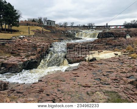 The Big Sioux River Flows Over Rocks In Sioux Falls South Dakota With Views Of Wildlife, Ruins, Park