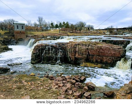 The Big Sioux River Flows Over Rocks In Sioux Falls South Dakota With Views Of Wildlife, Ruins, Park