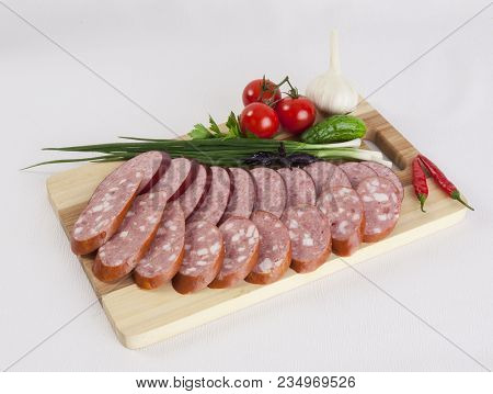 Still Life With Sliced Smoked Sausage Greens And Tomatoes On A White Background. Can Be Used For Ban