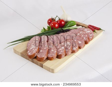 Still Life With Sliced Smoked Sausage Greens And Tomatoes On A White Background. Can Be Used For Ban