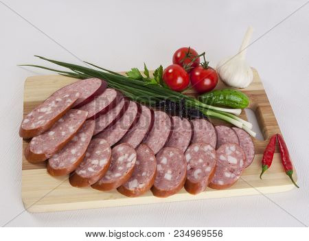 Still Life With Sliced Smoked Sausage Greens And Tomatoes On A White Background. Can Be Used For Ban