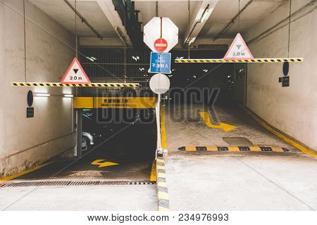 In Front Of Multi-level Car Parking Indoor In Apartment Buildings In Hong Kong. Entrance And Exit Wa