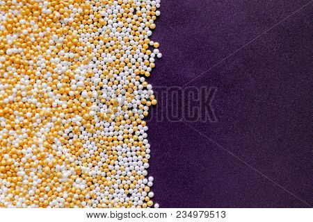 White, Gold, Shiny And Tiny Sugar Balls Background On Purple Velvet Background Surface With Free Spa