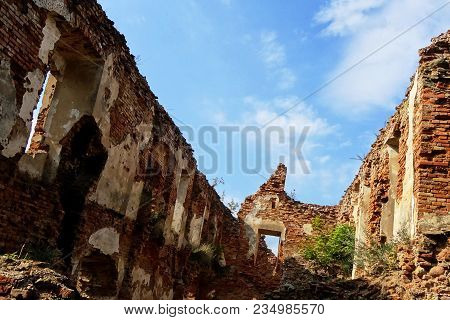 An Old Broken Brick Wall With Cracks. Ruined Wall Of The Old Cathedral.