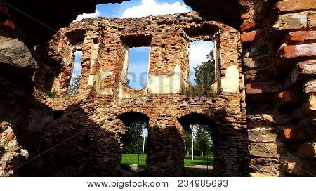 An Old Broken Brick Wall With Cracks. Ruined Wall Of The Old Cathedral.