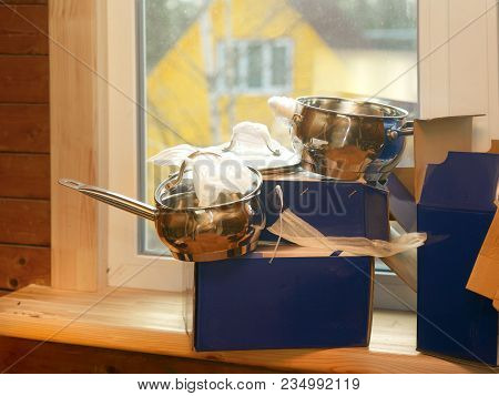 Unboxing Of A Brand New Casseroles Set Placed On The Window Sill