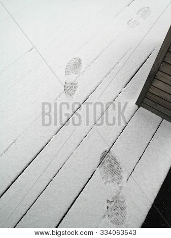 Traces Of Men's Shoes On White Snow