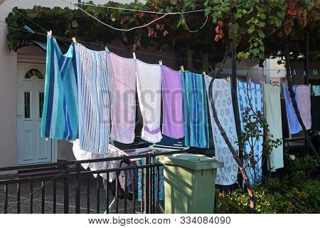 Washing Line With Drying Clothes In Outdoor. Clothes Hanging On Washing Line.