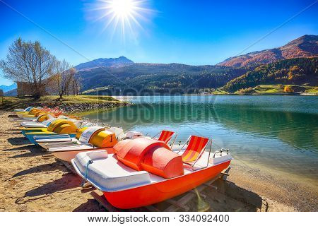Bright Autumn View Of San Valentino Village And Muta Lake (haidersee) .
Location: Lago Della Muta Or
