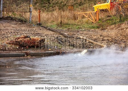 Hot Water Is Pumped Out Onto The Road Using A Pump And A Fire Hose From A Fire Engine, Hot Water For