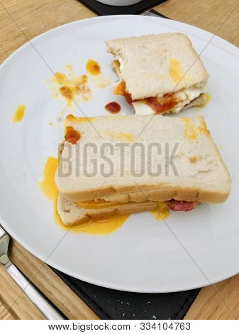 White Bread Bacon And Egg Runny Sandwich