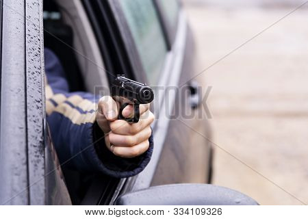 Man With A Gun Driving A Car, Male Hand With A Gun