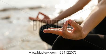 Unrecognizable Woman Practicing Yoga Lesson In Lotus Position Doing Ardha Padmasana Exercise, Closeu