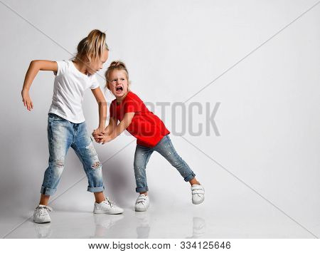 Elder Sister Is Pulling Younger By Hand Painfully, Abusing, Punishing, Taking Something Away. Baby G