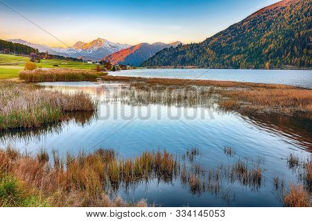 Splendid Autumn Panorama Of Haidersee (lago Della Muta) Lake With Ortler Peak On Background.
Locatio