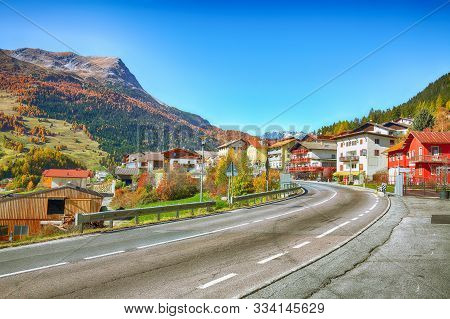 Bright Autumn View Of San Valentino Village And Muta Lake (haidersee) .
Location: Lago Della Muta Or