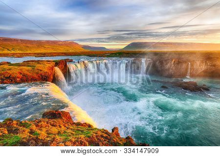 Fantastic Sunrise Scene Of Powerful Godafoss Waterfall. Dramatic Sky Over Godafoss. Location: Bardar