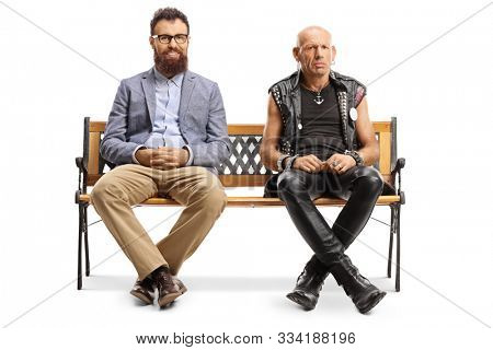 Full length portrait of a smiling bearded man and a grumpy punker sitting on a bench isolated on white background