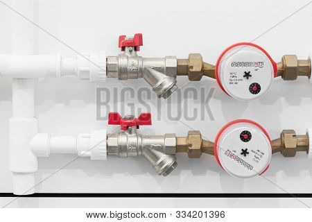Water Pipes With Water Meters On White Wall Background. Pipeline Background.