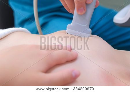 Ultrasound Scanning Diagnostic Of Woman Mammary Glands In Clinic, Closeup View. Doctor Runs Ultrasou