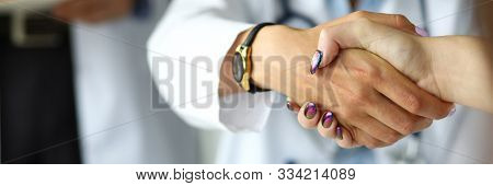 Arm Of Female Gp Shaking Hands With Visitor Close-up. Self Introduction Cheering Or Problem Solution
