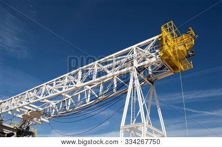 Drilling Rig Derrick Resting On Support Stand In Houston Yard.
